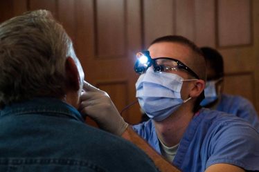 Dentist evaluating a service member.