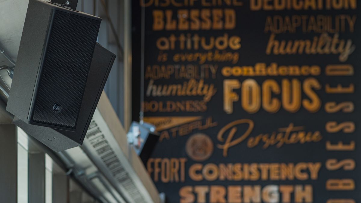 A DAS Audio speaker in front of the Legacy Fitness sign.