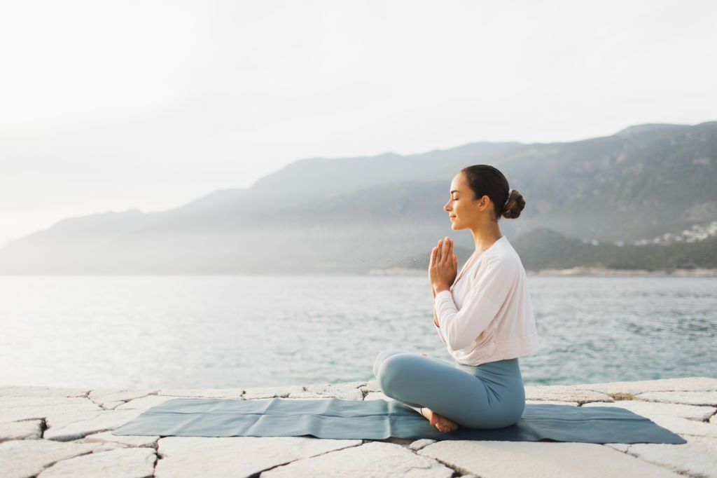 Quiet and relax. Self-analysis and sensitivity. Girl practicing yoga outdoors. Beauty in nature