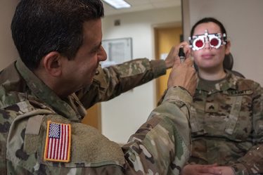 Image of U.S. Army Col. (Dr.) Frank Valentin, chief of ophthalmology, checks a patient for double vision and convergence at Brooke Army Medical Center, Fort Sam Houston, Texas. Recruiting qualified health care providers across the MHS is the first step in the stabilization of MHS, aligning with the MHS Strategy.  (U.S. Army photo by Jason W. Edwards).